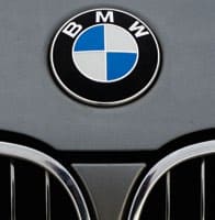 cropped photo of bmw emblem on the hood of a bmw